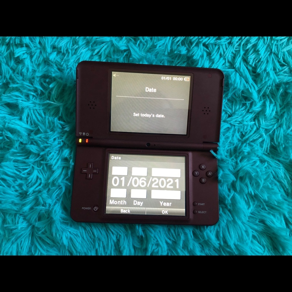 Nintendo DSi XL. (Color: Maroon/Red)